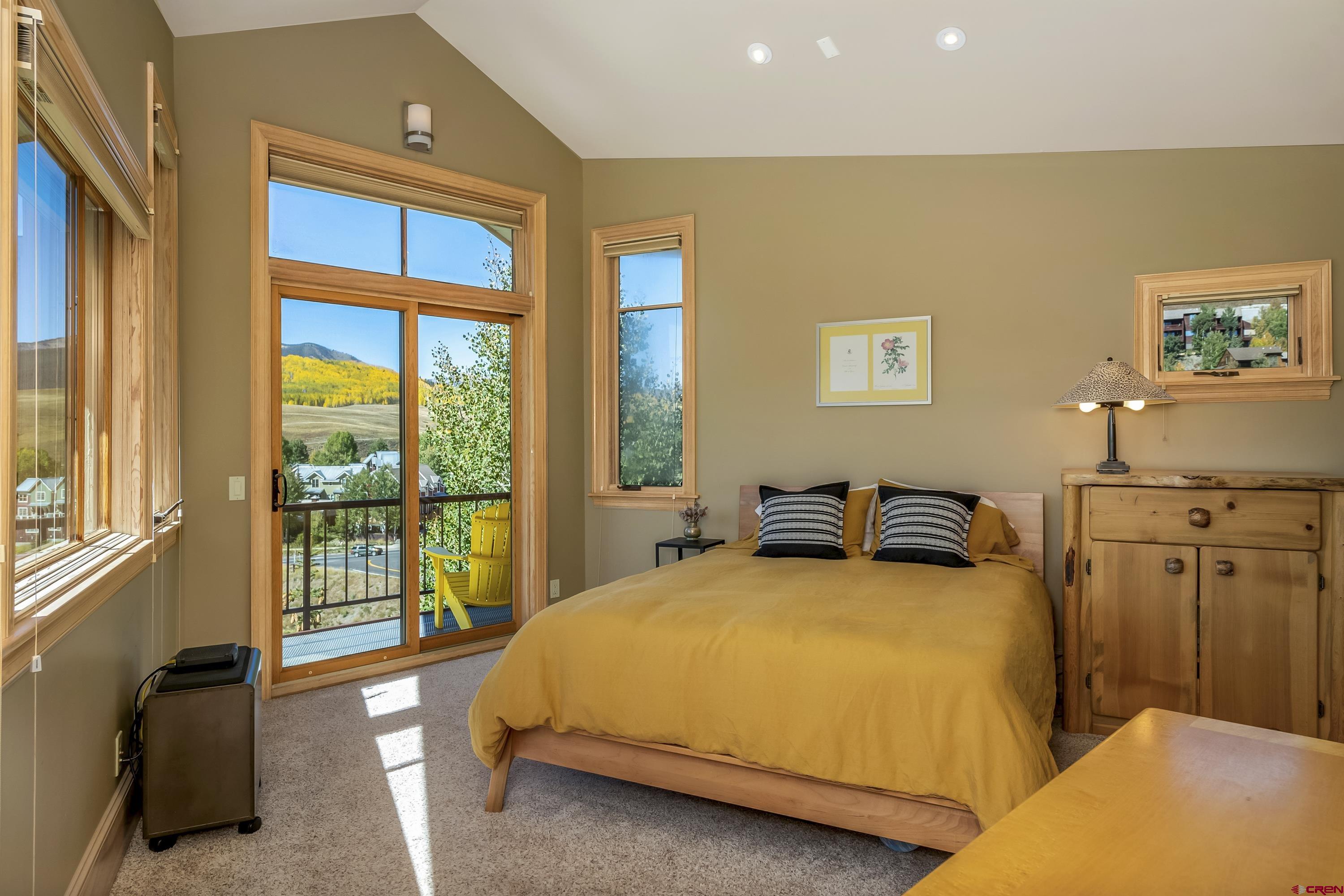 19 Castle Road, Unit 5 Crested Butte, CO 81225 - Photo 14 of 32 a bedroom with bed and glass door