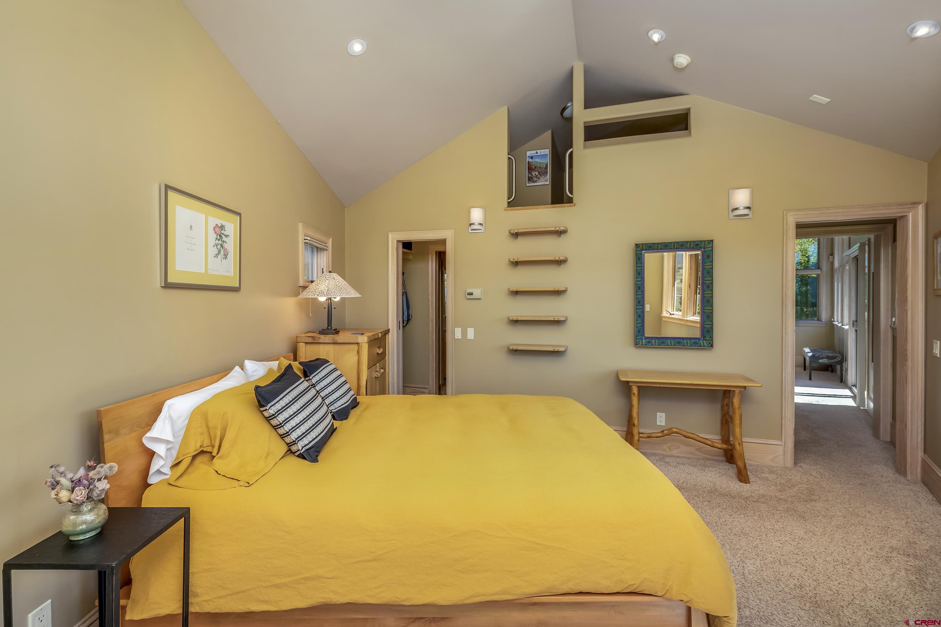 19 Castle Road, Unit 5 Crested Butte, CO 81225 - Photo 15 of 32 a spacious bedroom with a bed and a table