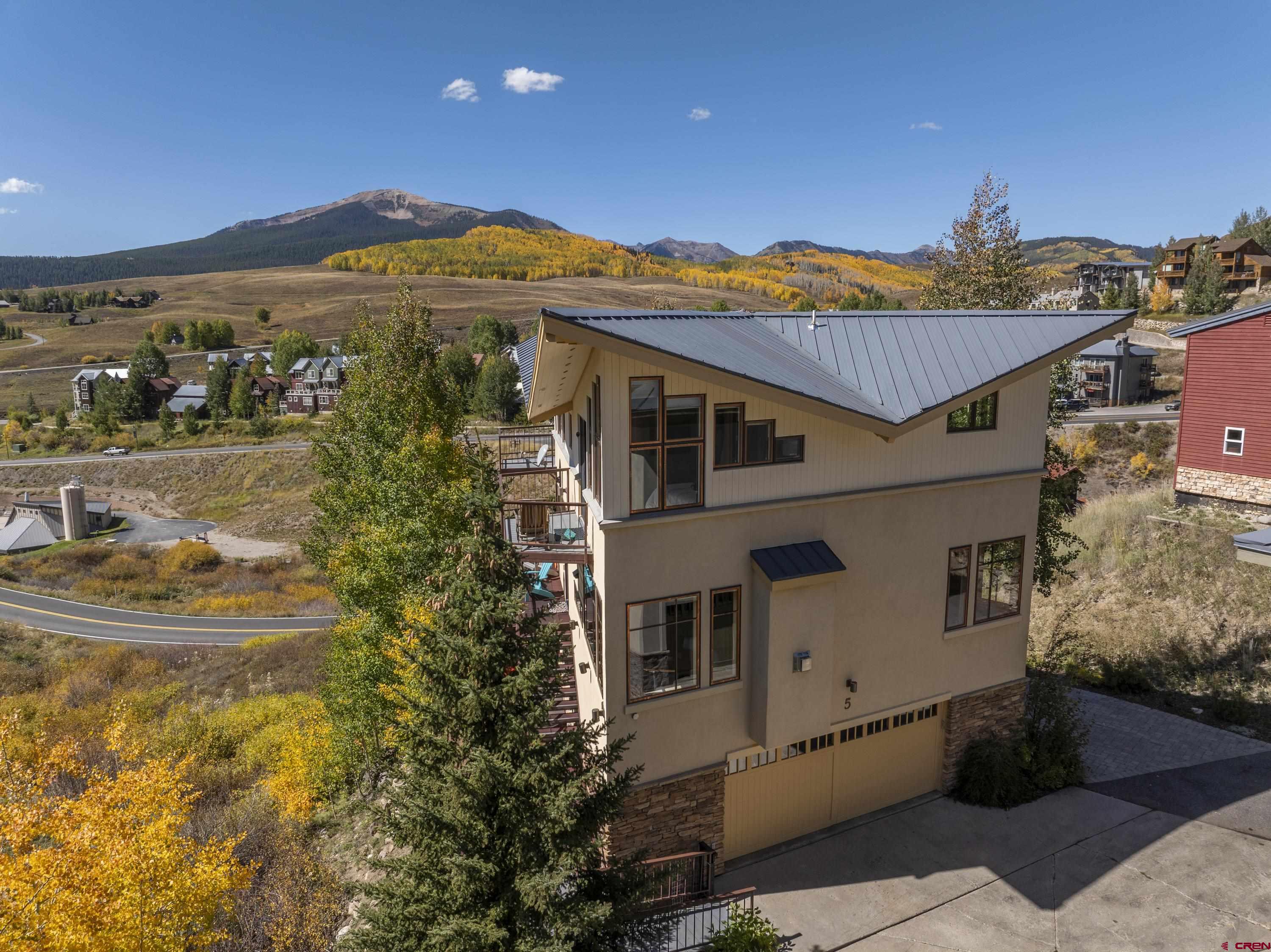 19 Castle Road, Unit 5 Crested Butte, CO 81225 - Photo 28 of 32 a view of a white house with a big yard and potted plants