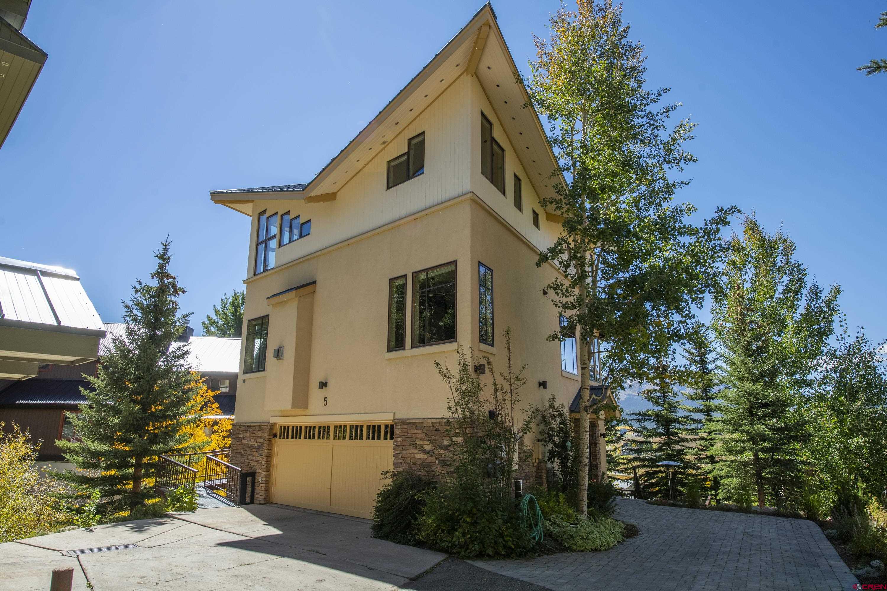19 Castle Road, Unit 5 Crested Butte, CO 81225 - Photo 4 of 32 a white house with tree in front of it