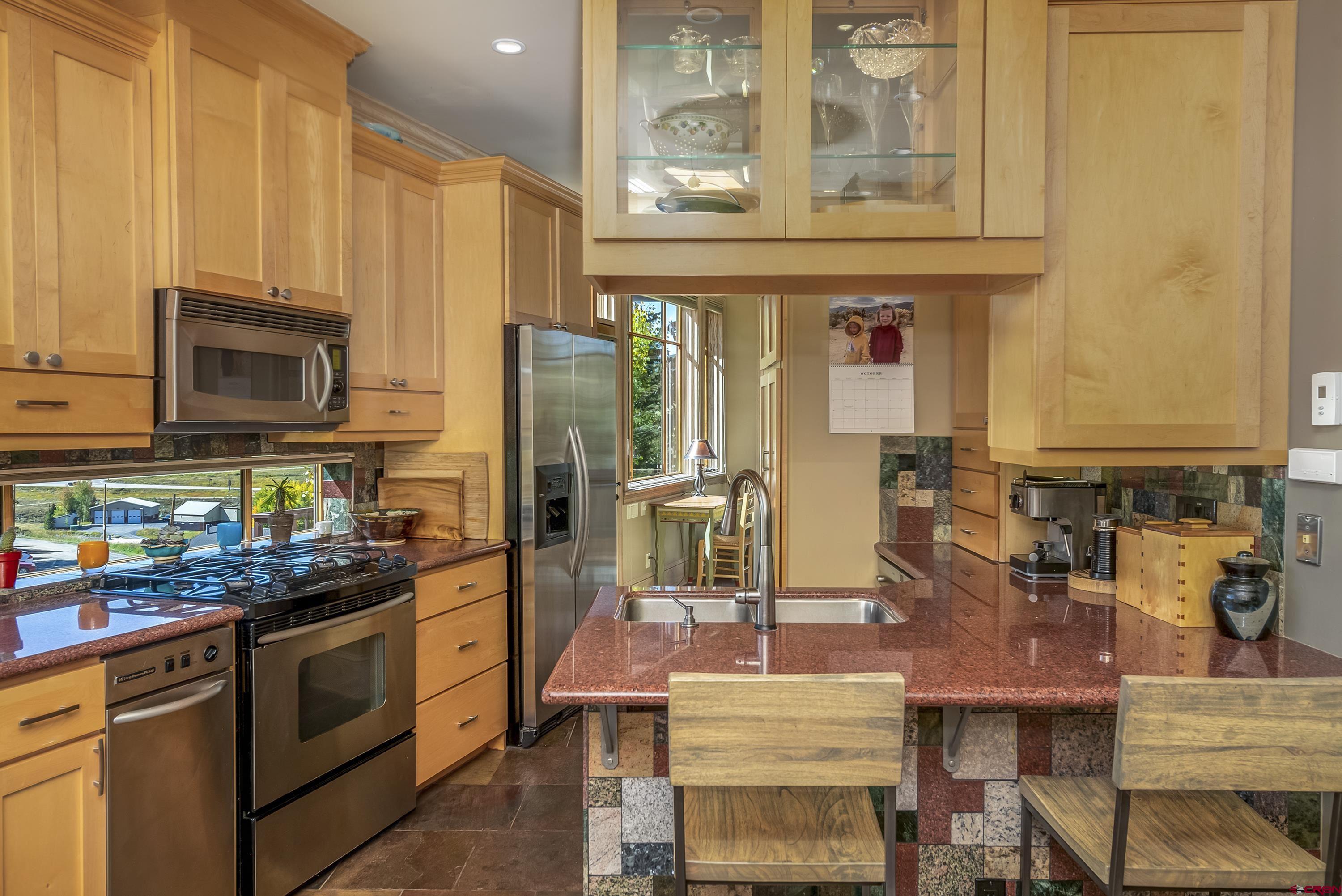 19 Castle Road, Unit 5 Crested Butte, CO 81225 - Photo 9 of 32 a kitchen with stainless steel appliances a stove refrigerator sink and cabinets