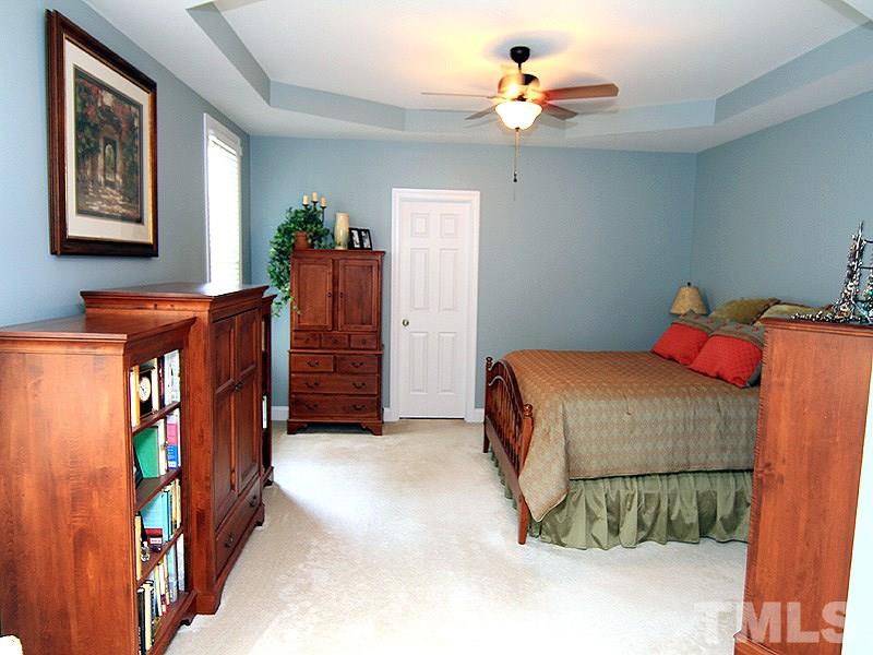 2208 Karns Place Raleigh, NC 27614 - Photo 14 of 25 a bedroom with a bed and a chandelier