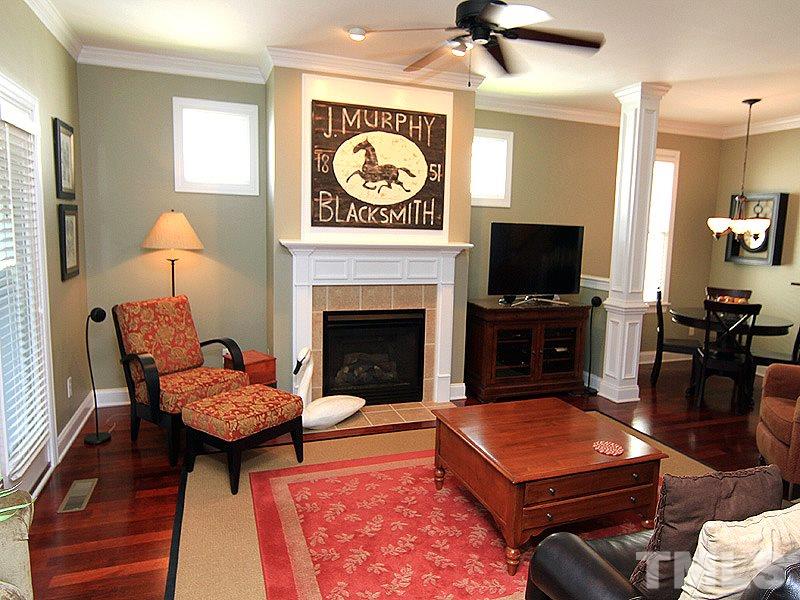 2208 Karns Place Raleigh, NC 27614 - Photo 7 of 25 a living room with furniture a flat screen tv and a fireplace
