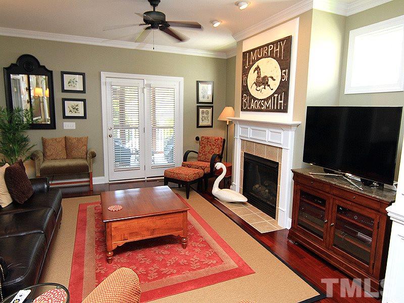 2208 Karns Place Raleigh, NC 27614 - Photo 8 of 25 a living room with furniture a flat screen tv and a fireplace