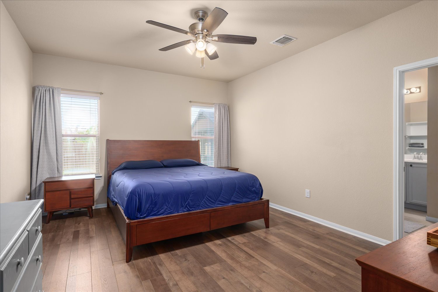 717 Kaluga Trail Leander, TX 78641 - Photo 15 of 40 a bedroom with a bed chandelier and a window