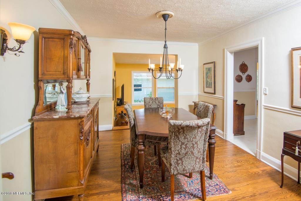 1128 Greenridge Road Jacksonville, FL 32207 - Photo 15 of 37 a dining room with furniture a chandelier and wooden floor