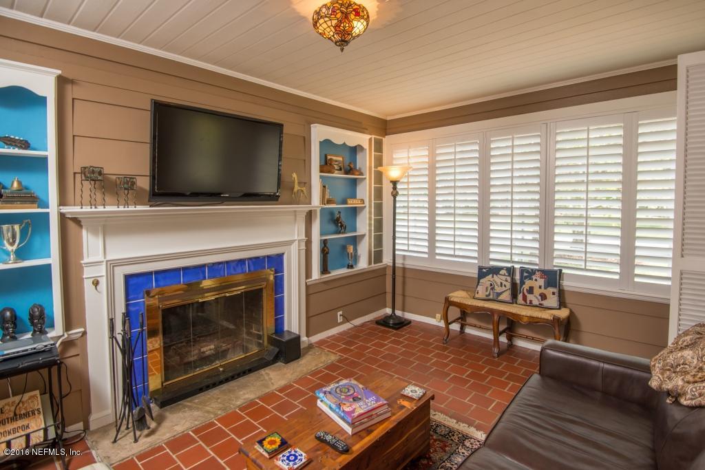 1128 Greenridge Road Jacksonville, FL 32207 - Photo 18 of 37 a living room with furniture a flat screen tv and a fireplace