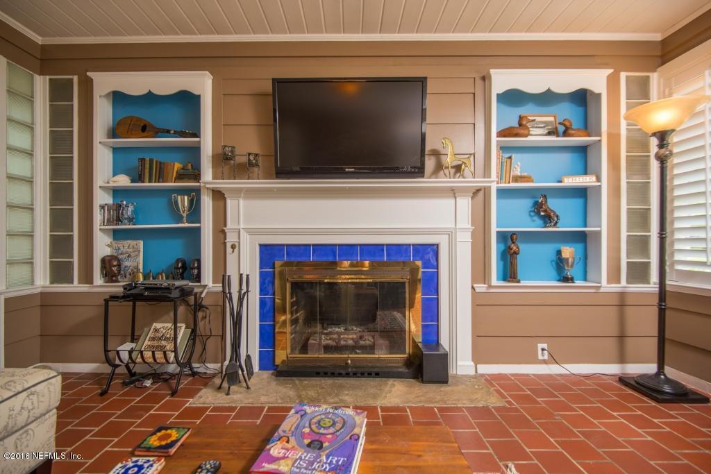 1128 Greenridge Road Jacksonville, FL 32207 - Photo 19 of 37 a living room with a fireplace and a flat screen tv