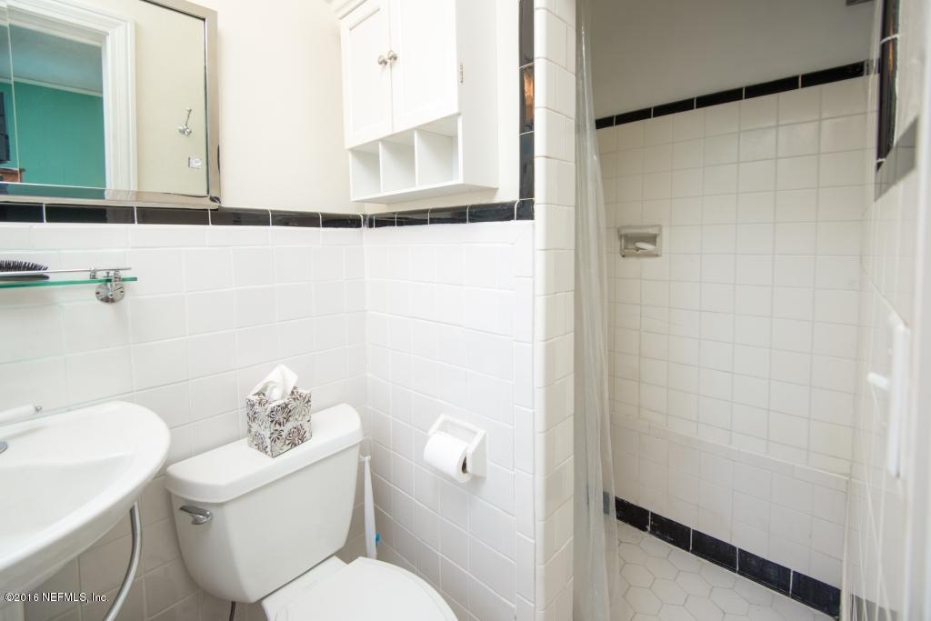 1128 Greenridge Road Jacksonville, FL 32207 - Photo 22 of 37 a white toilet sitting next to a bathroom sink
