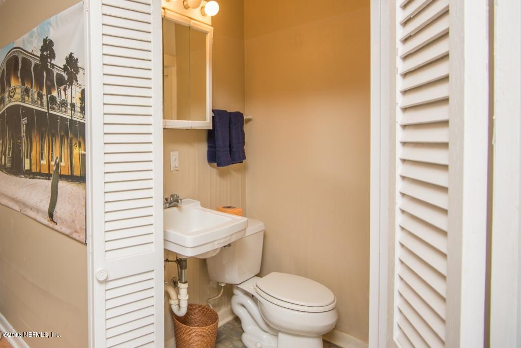 1128 Greenridge Road Jacksonville, FL 32207 - Photo 33 of 37 a bathroom with a sink a toilet and shower