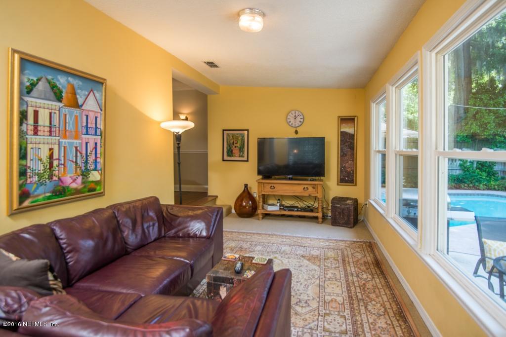 1128 Greenridge Road Jacksonville, FL 32207 - Photo 4 of 37 a living room with furniture and a flat screen tv