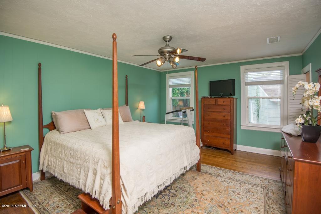 1128 Greenridge Road Jacksonville, FL 32207 - Photo 7 of 37 a bedroom with a bed and a chandelier