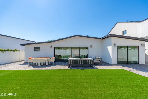 a view of a house with backyard and a patio