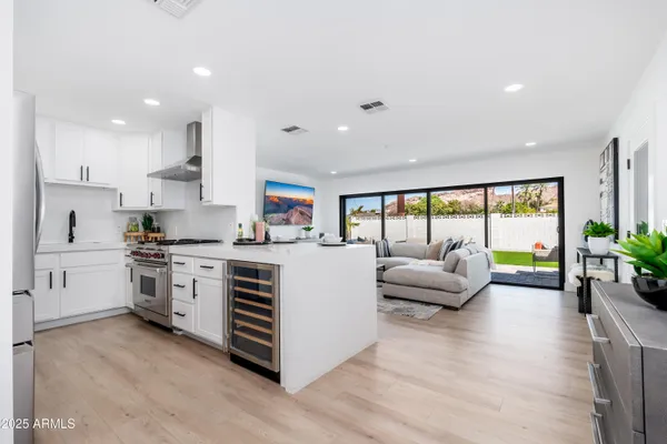 a kitchen with white cabinets and white appliances