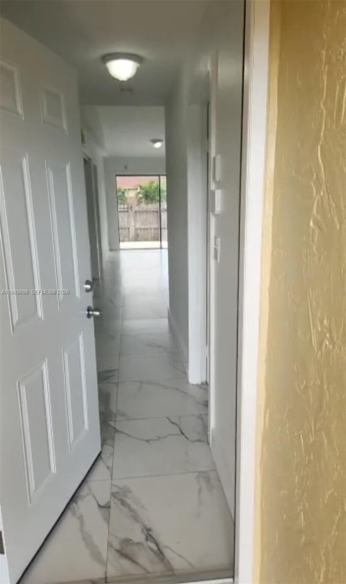 13949 Southwest 281st Terrace, Unit 13949 Homestead, FL 33033 - Photo 2 of 11 a bathroom with a glass shower door