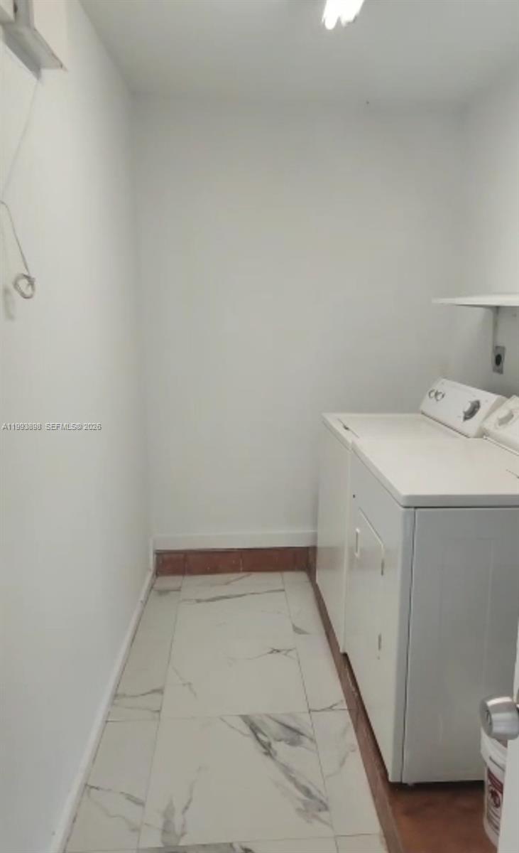 13949 Southwest 281st Terrace, Unit 13949 Homestead, FL 33033 - Photo 5 of 11 a utility room with dryer and washer
