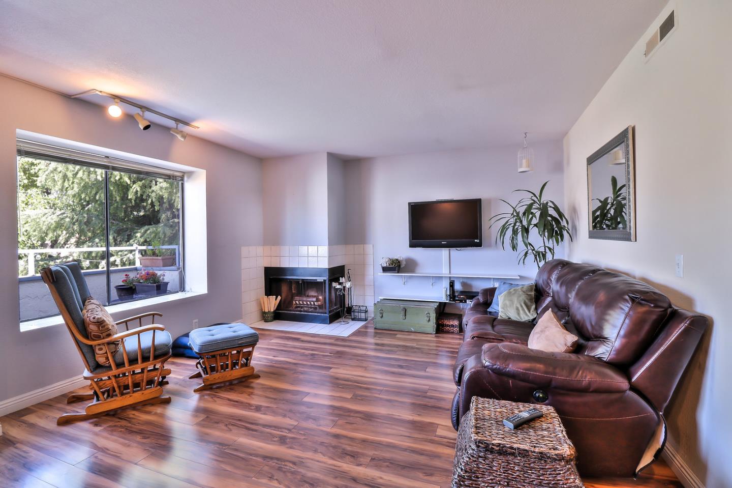 87 Redding Road Campbell, CA 95008 - Photo 1 of 12 a living room with furniture a flat screen tv and a fireplace