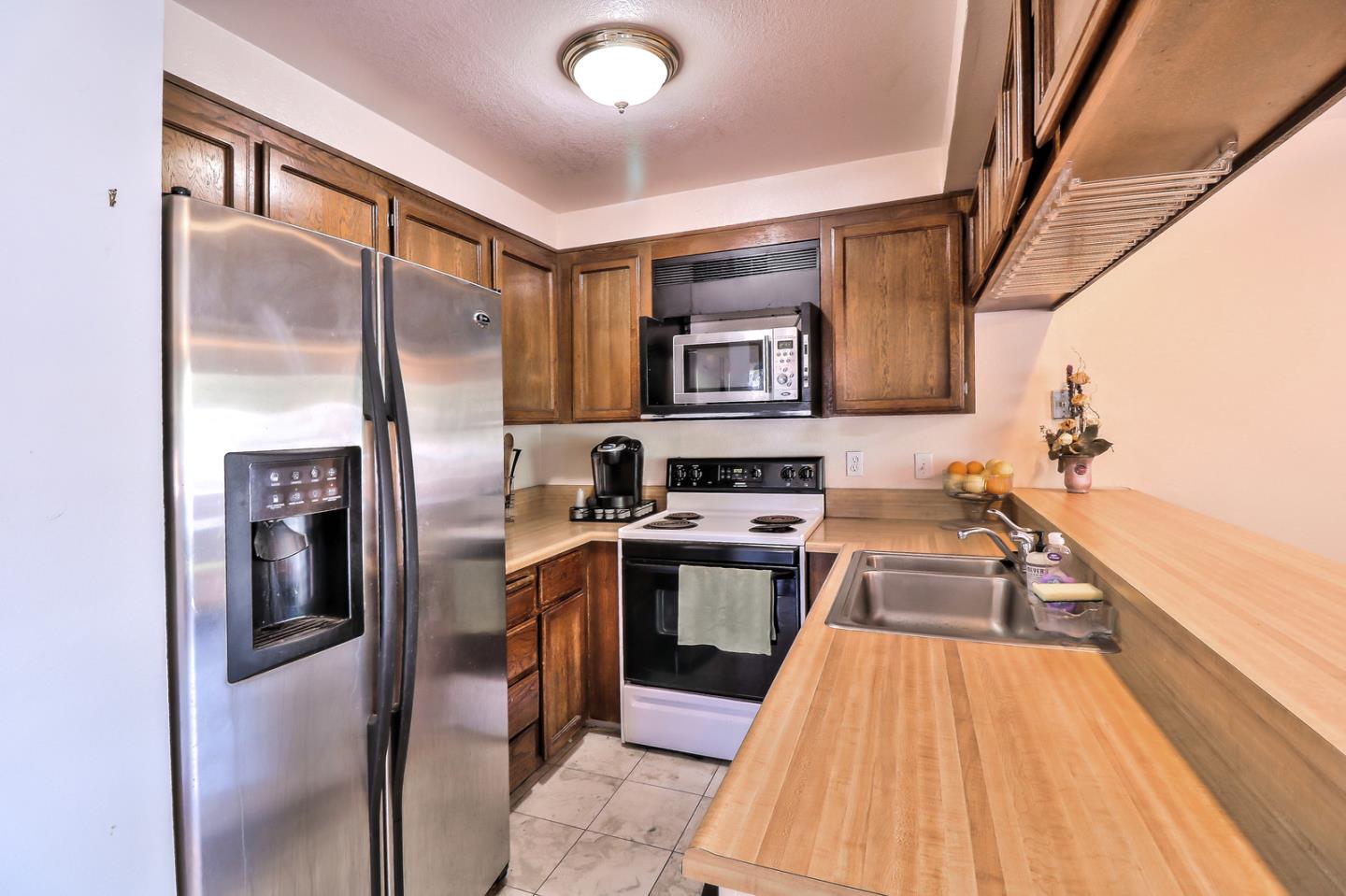 87 Redding Road Campbell, CA 95008 - Photo 3 of 12 a kitchen with stainless steel appliances granite countertop a refrigerator a stove and a sink