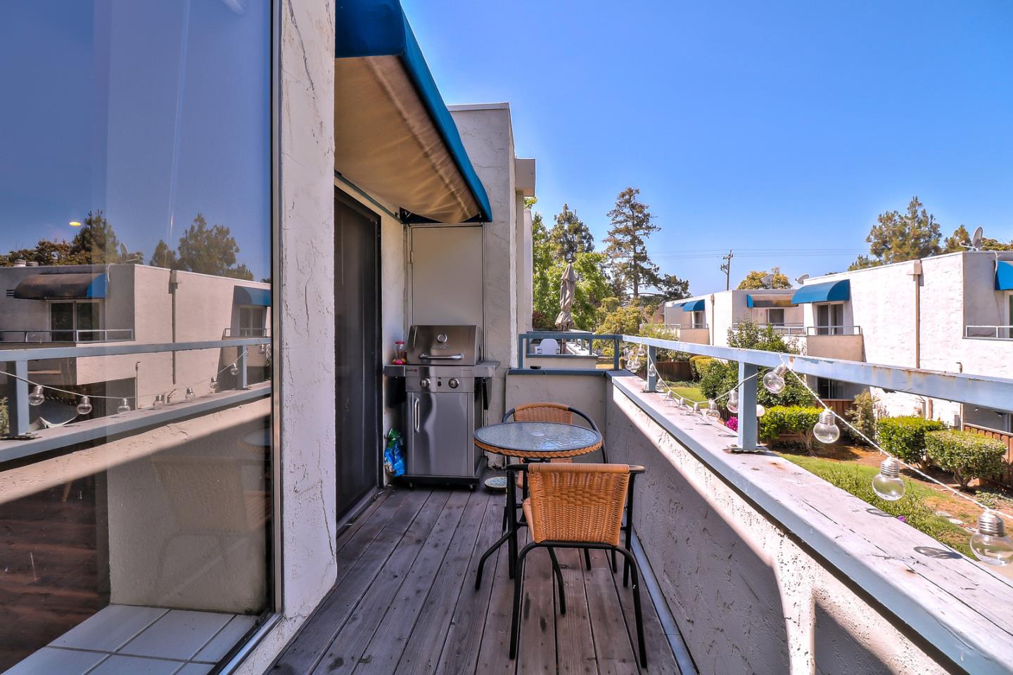 87 Redding Road Campbell, CA 95008 - Photo 8 of 12 a balcony with outdoor seating and wooden floor