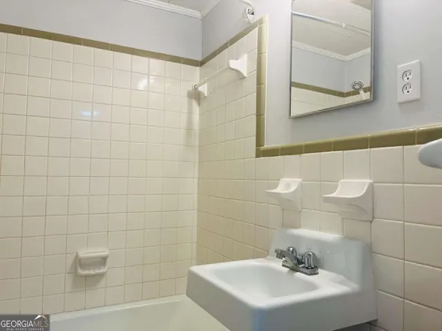 a bathroom with a sink a shower and a mirror