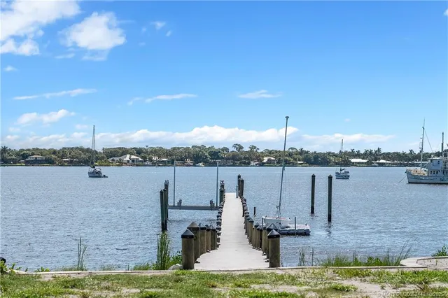 a view of a lake with couches chairs