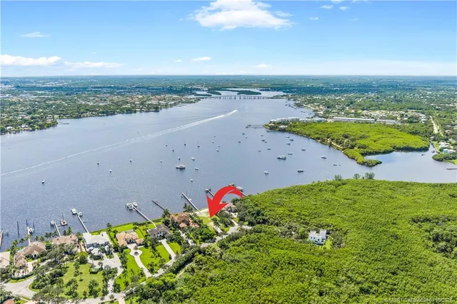 an aerial view of a houses with a lake view