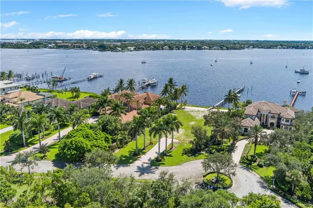 an aerial view of a houses with a lake view