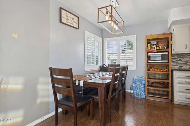 a view of a dining room with furniture and wooden floor