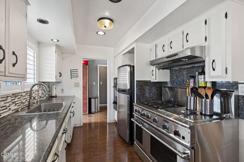 729 Ralph Way Santa Paula, CA 93060 - Photo 17 of 55 a kitchen with stainless steel appliances granite countertop a stove a sink and a refrigerator