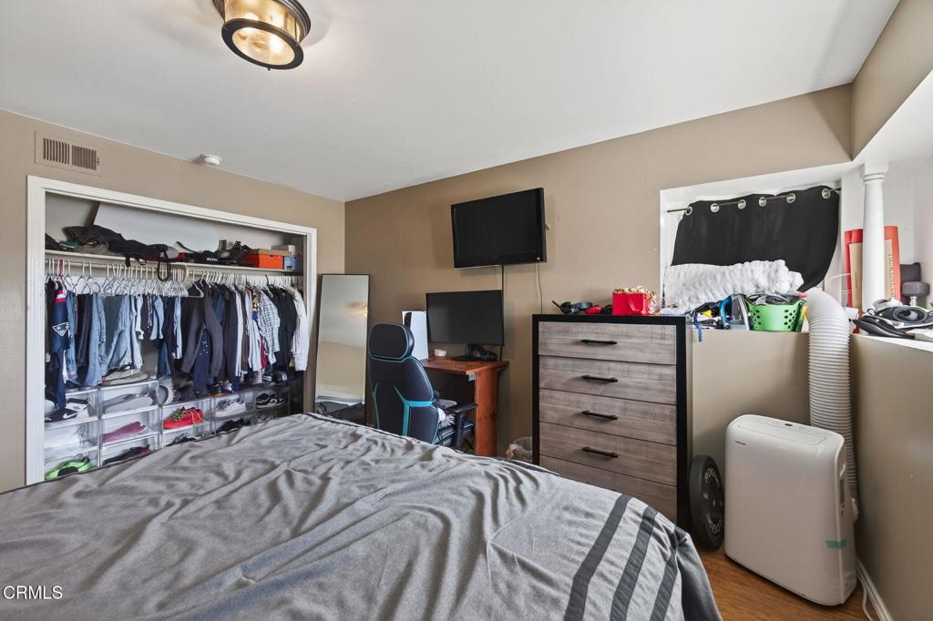 729 Ralph Way Santa Paula, CA 93060 - Photo 22 of 55 a bedroom with a bed a flat screen tv and a couch
