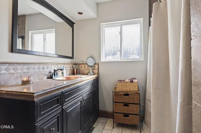 a bathroom with a sink vanity and a mirror