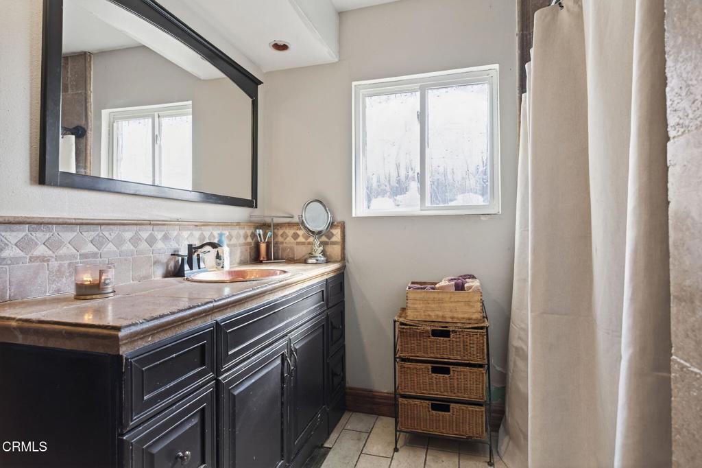 729 Ralph Way Santa Paula, CA 93060 - Photo 24 of 55 a bathroom with a sink vanity and a mirror