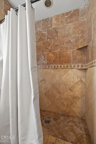 a kitchen with granite countertop a refrigerator sink stove and microwave