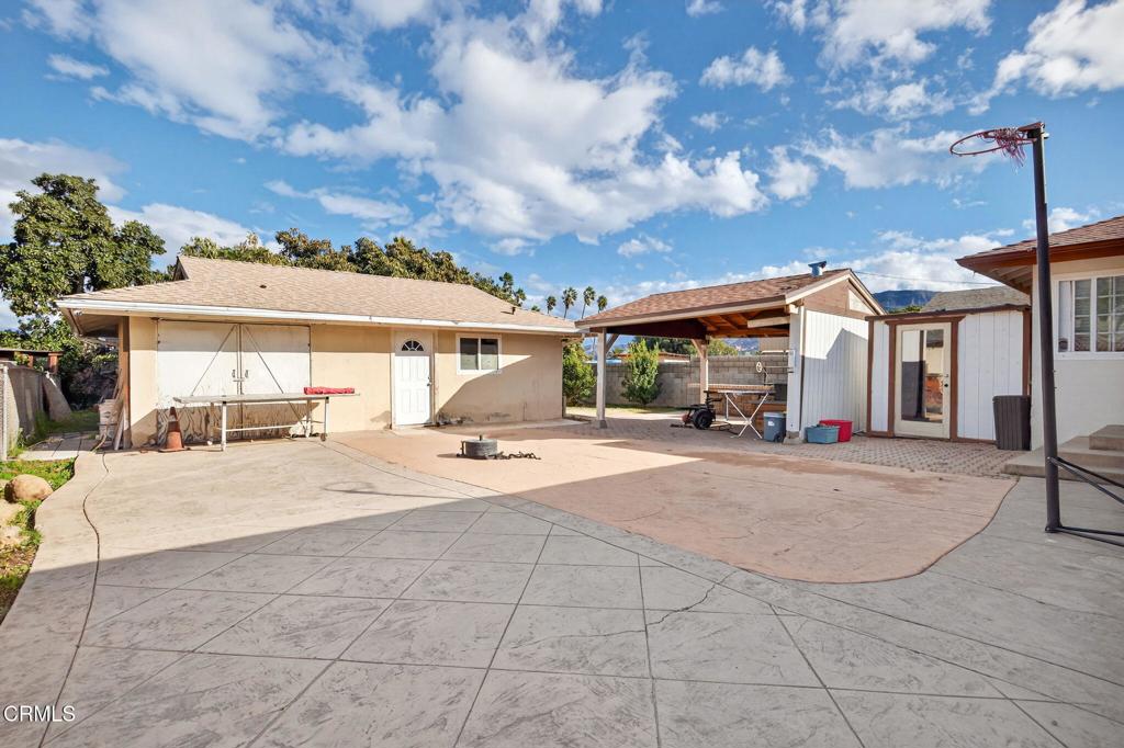 729 Ralph Way Santa Paula, CA 93060 - Photo 34 of 55 a patio with a table and chairs under an umbrella