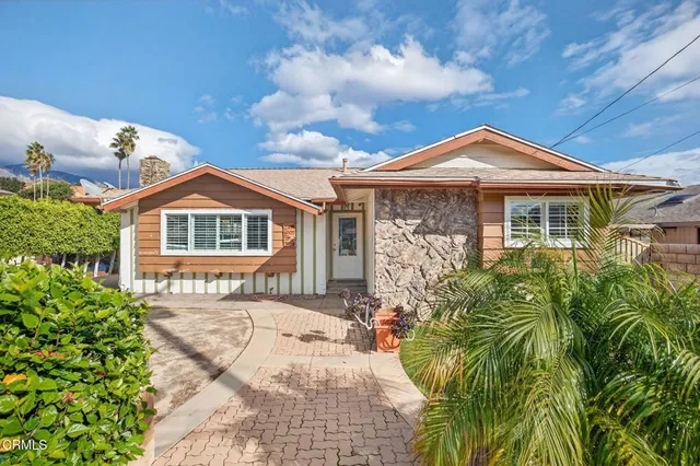a front view of a house with a garden