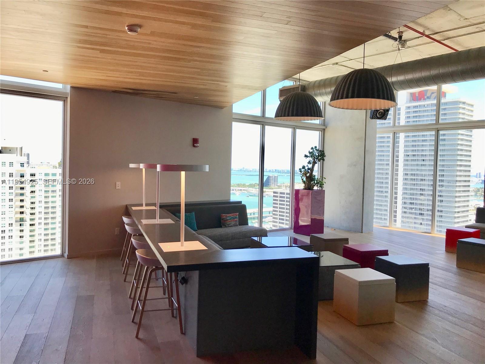 151 Southeast 1st Street, Unit 904 Miami, FL 33131 - Photo 24 of 34 a living room with furniture and floor to ceiling windows