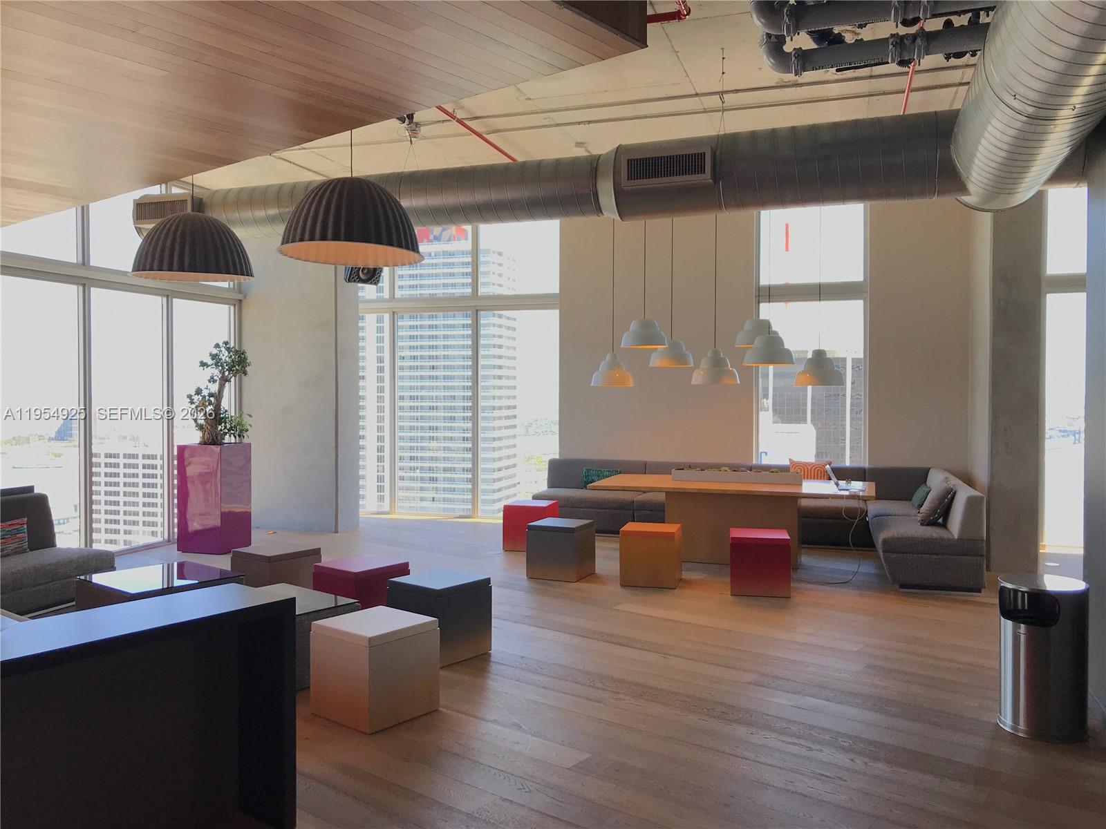 151 Southeast 1st Street, Unit 904 Miami, FL 33131 - Photo 25 of 34 a living room with furniture and wooden floor