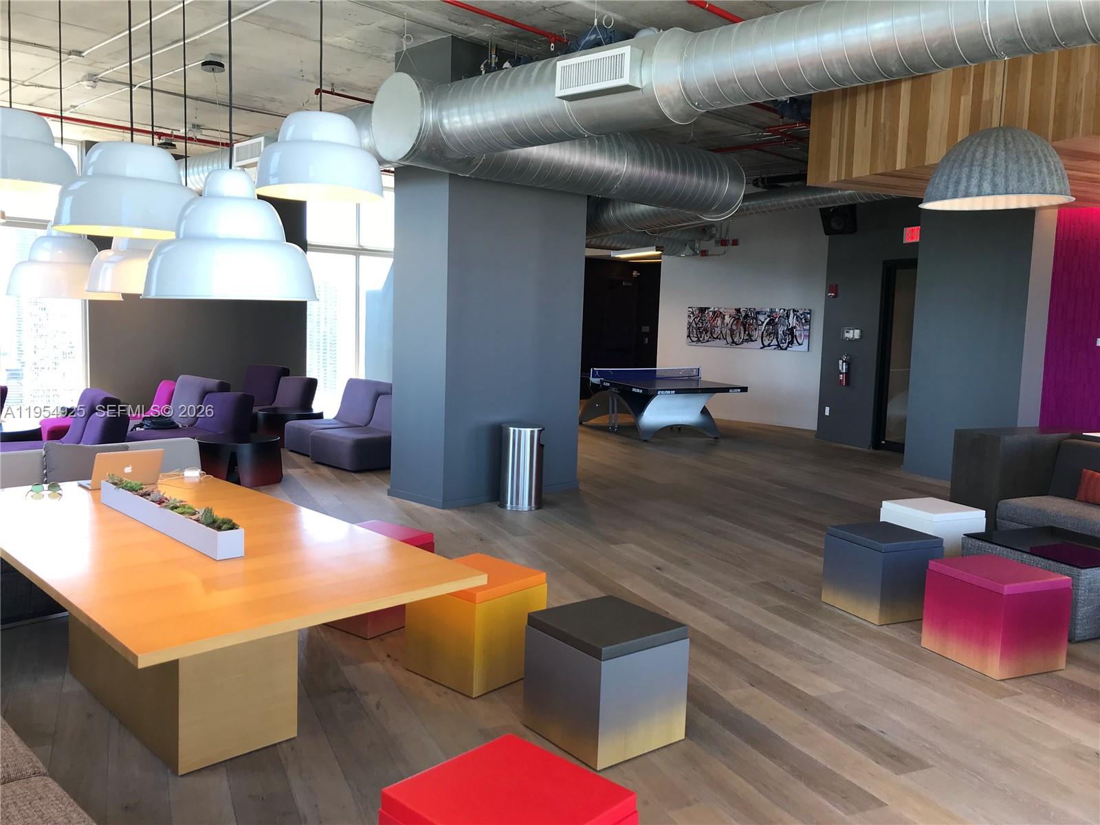 151 Southeast 1st Street, Unit 904 Miami, FL 33131 - Photo 26 of 34 a living room with furniture and a chandelier