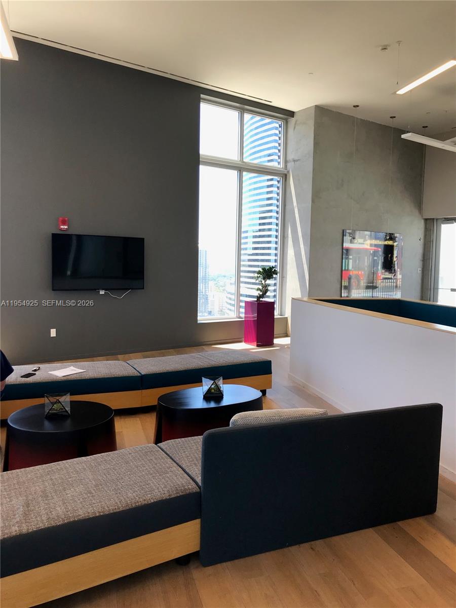 151 Southeast 1st Street, Unit 904 Miami, FL 33131 - Photo 30 of 34 a living room with furniture window and flat screen tv