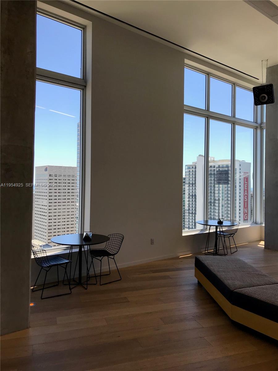 151 Southeast 1st Street, Unit 904 Miami, FL 33131 - Photo 32 of 34 a living room with a bed and a window