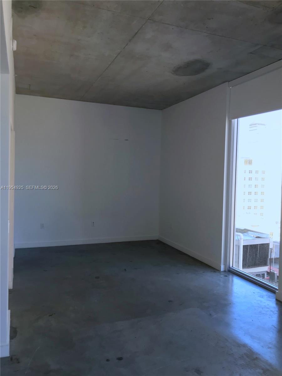 151 Southeast 1st Street, Unit 904 Miami, FL 33131 - Photo 6 of 34 a view of an empty room with wooden floor and a fireplace
