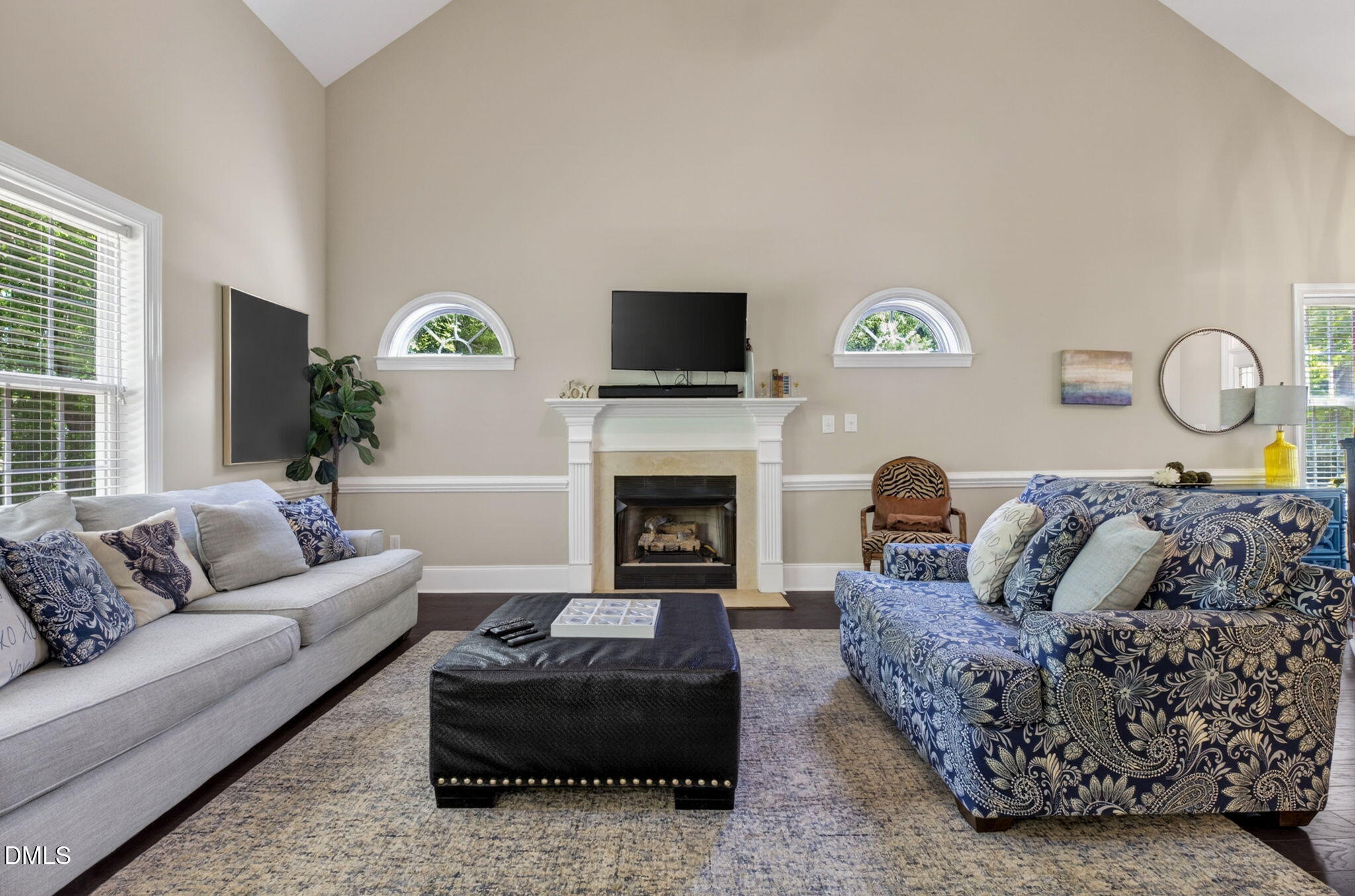 59 Ariel Court Garner, NC 27529 - Photo 10 of 36 a living room with furniture a flat screen tv and a fireplace