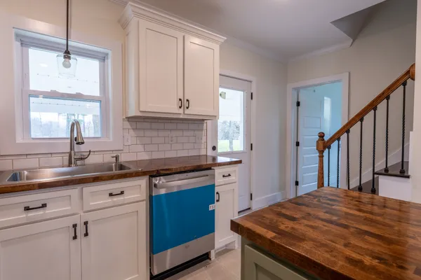 a kitchen with stainless steel appliances granite countertop a sink stove and cabinets