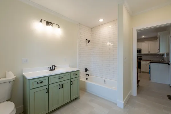 a spacious bathroom with a bathtub sink and toilet