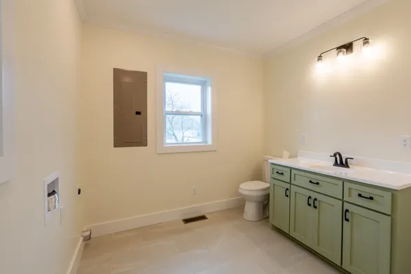 a bathroom with a toilet sink and mirror