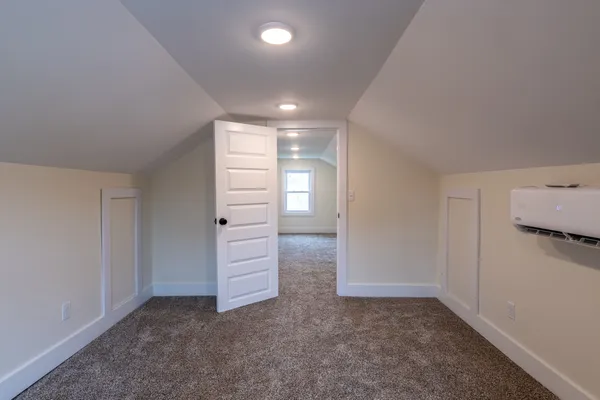 an empty room with windows and closet
