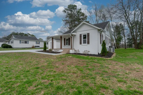 a front view of house with yard and green space