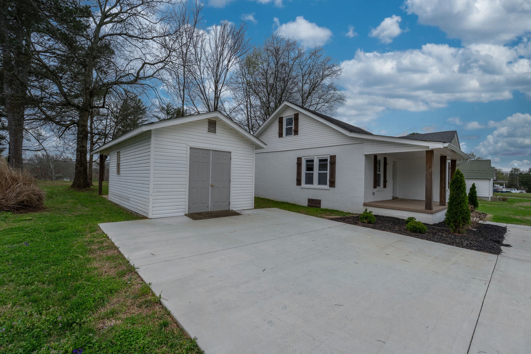 402 West Commerce Street Loretto, TN 38469 - Photo 5 of 23 a front view of a house with a yard and garage