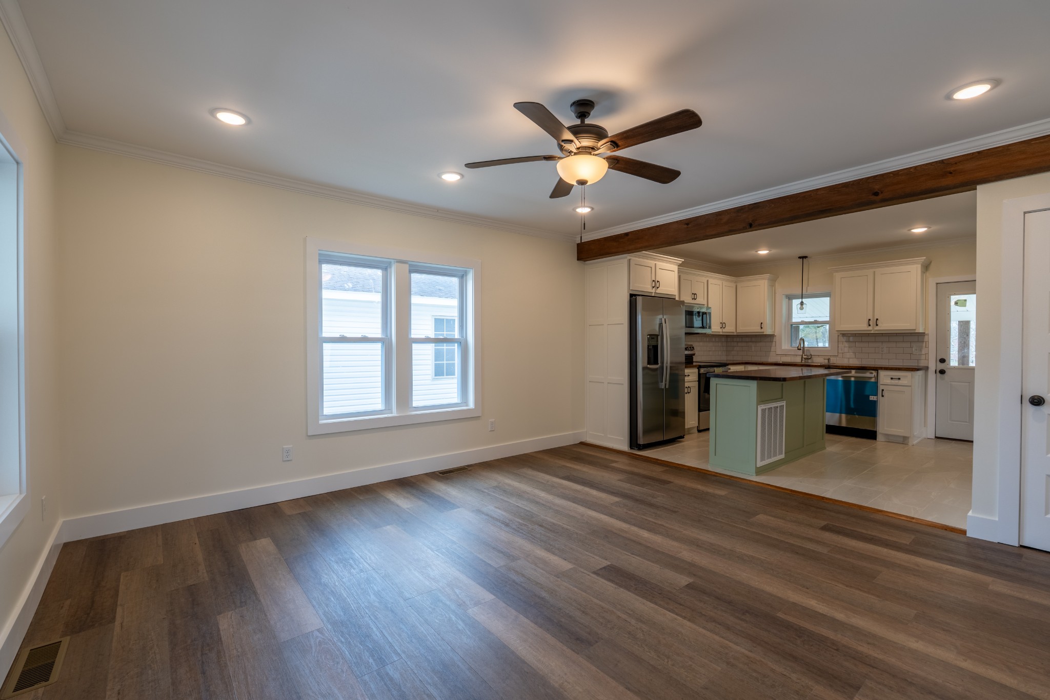 402 West Commerce Street Loretto, TN 38469 - Photo 7 of 23 a view of a kitchen with a stove cabinets and a wooden floor