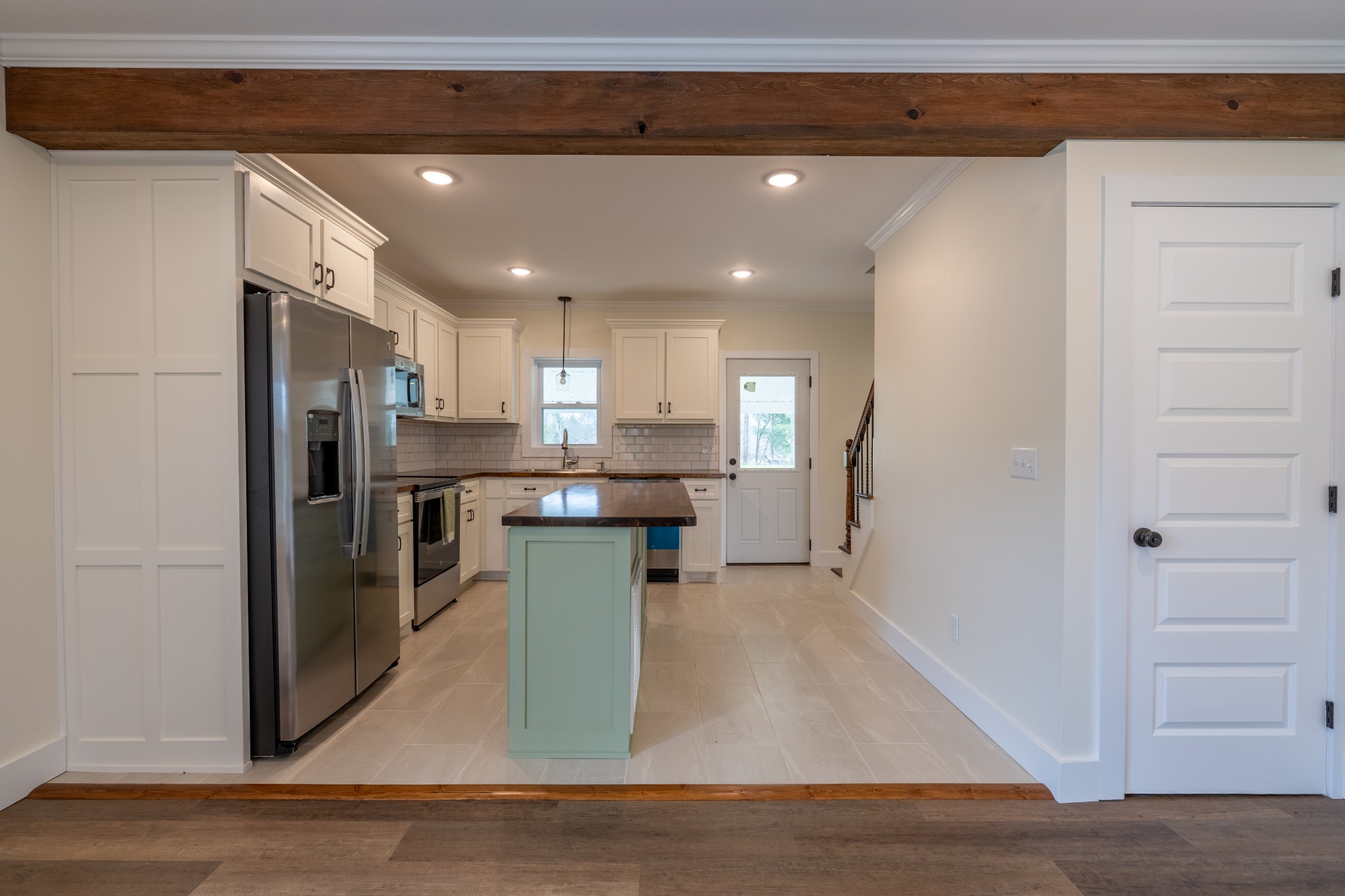 402 West Commerce Street Loretto, TN 38469 - Photo 9 of 23 a kitchen with stainless steel appliances kitchen island granite countertop a refrigerator and a sink